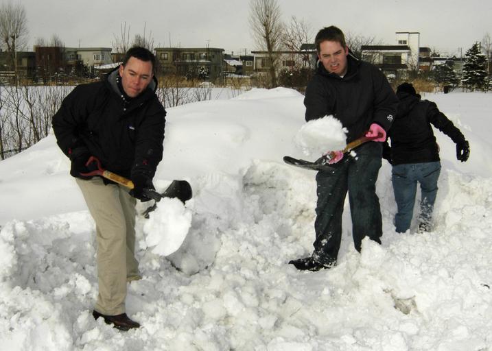 muži co odhazují sníh